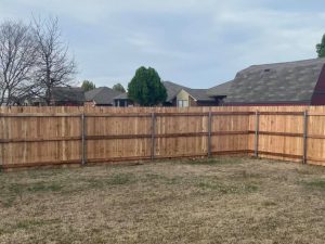 Photo of a stockade privacy wood fence with metal postmaster posts